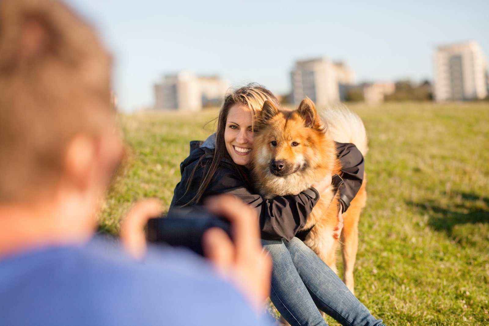woman hugs large dog for a photo
